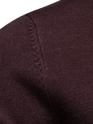 Plum purple ribbed mock neck sweater showing shoulder detail and textured knit fabric.