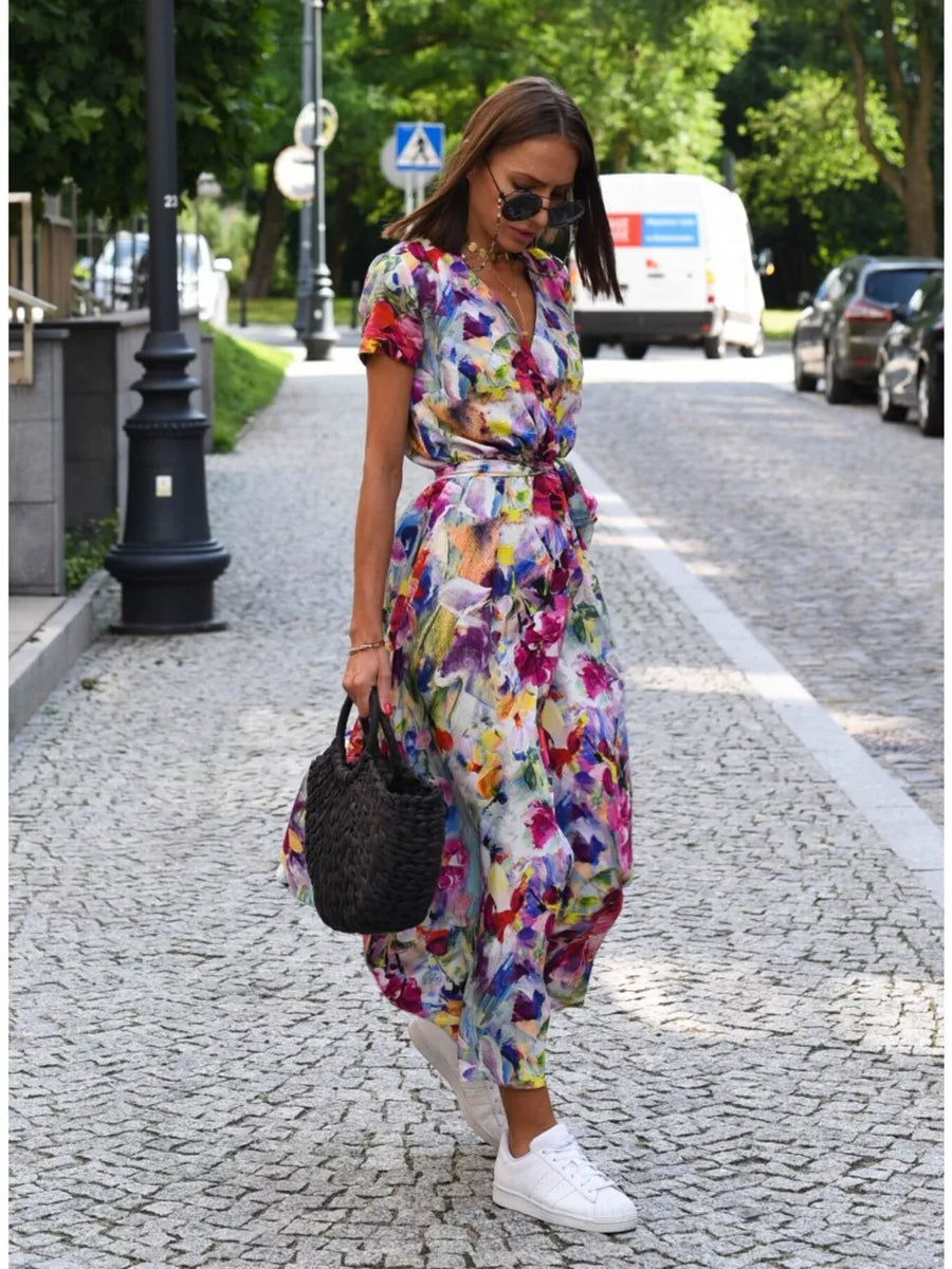 Wrap dress with colorful floral print, short sleeves, and tie waist.