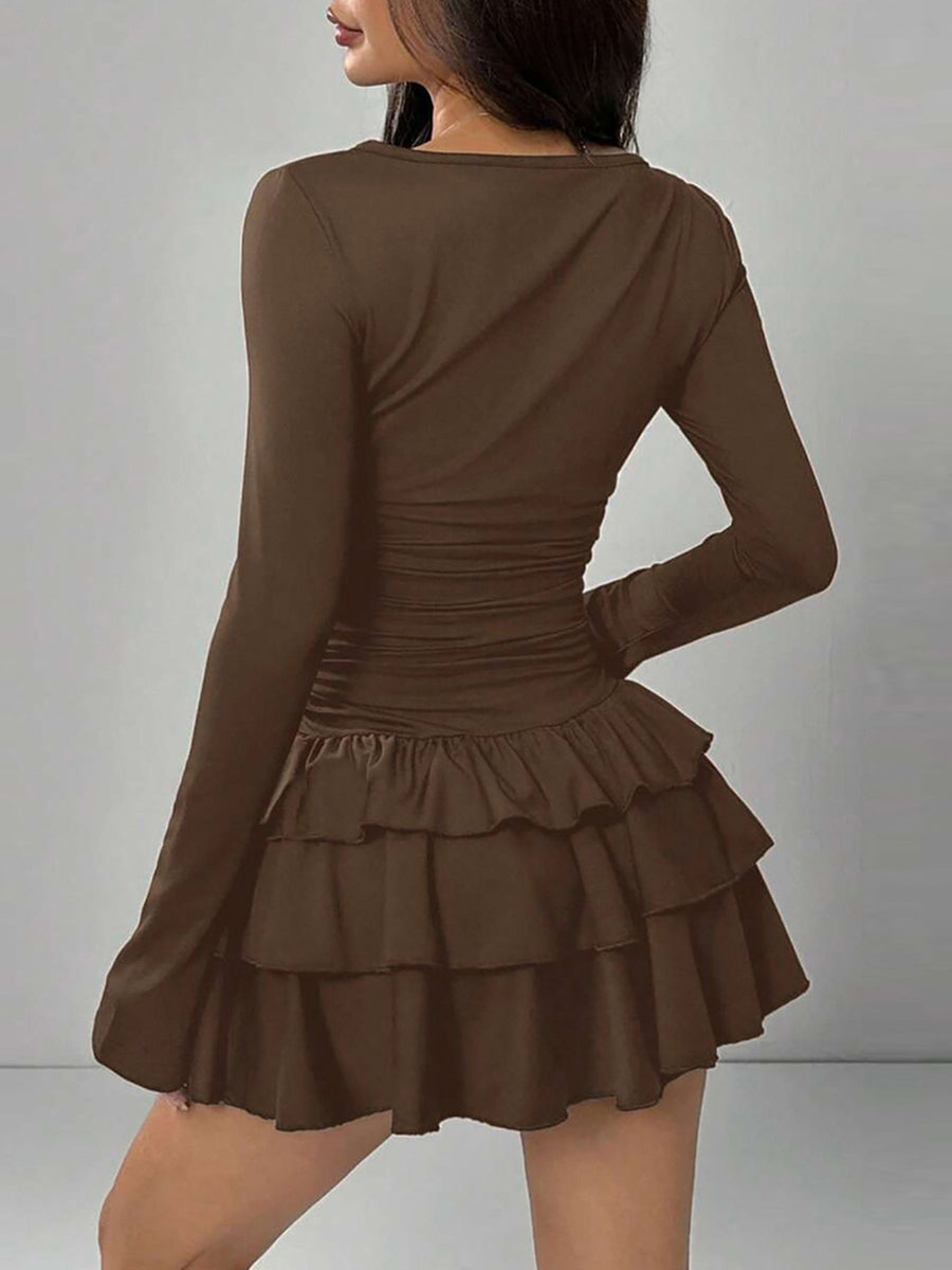 Brown long sleeve mini dress with tiered ruffle hem and ruched waist detail.