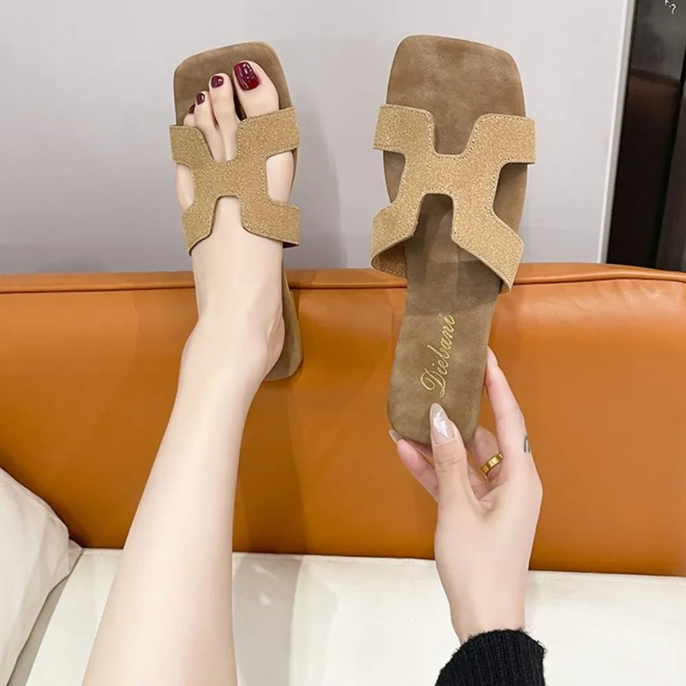 Camel suede H-strap flat sandals with square toe and textured straps.