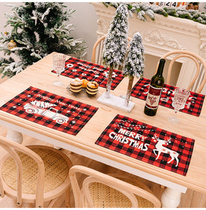 Festive plaid placemats with Christmas truck and reindeer designs.