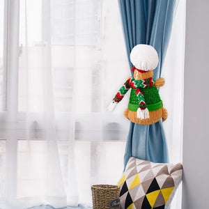 Gingerbread man curtain tieback in green with red and white striped scarf and white hat.