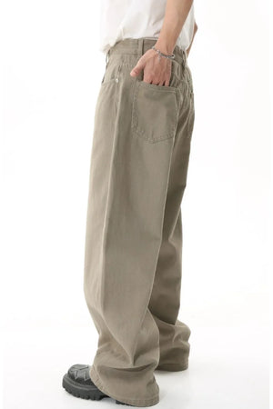 Khaki wide-leg denim jeans with a relaxed fit, shown from the side.