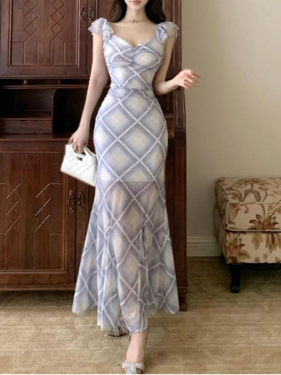 Blue ruched plaid bodycon maxi dress with ruffled cap sleeves and sweetheart neckline.