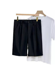 Black pleated chino shorts with pockets, shown with a white t-shirt.