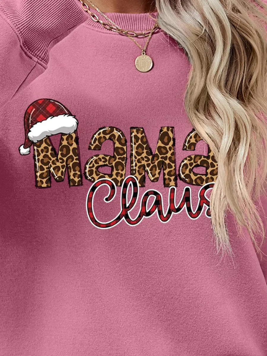 Blush pink crewneck sweatshirt with leopard print "Mama" and buffalo plaid "Claus" text, and Santa hat detail.