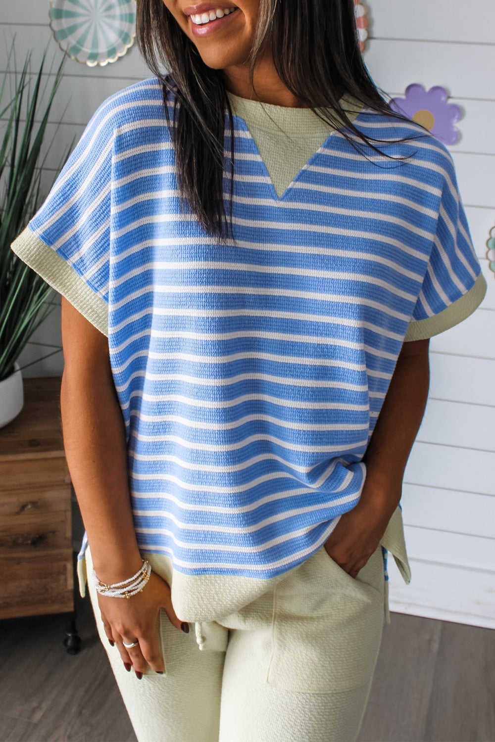 Relaxed fit blue and white striped t-shirt with a V-neck and contrasting trim.