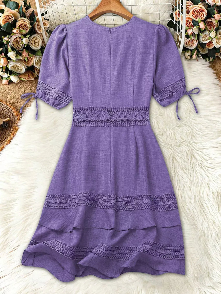 Purple lace-embellished V-neck mini dress with tiered hem and tie sleeves.