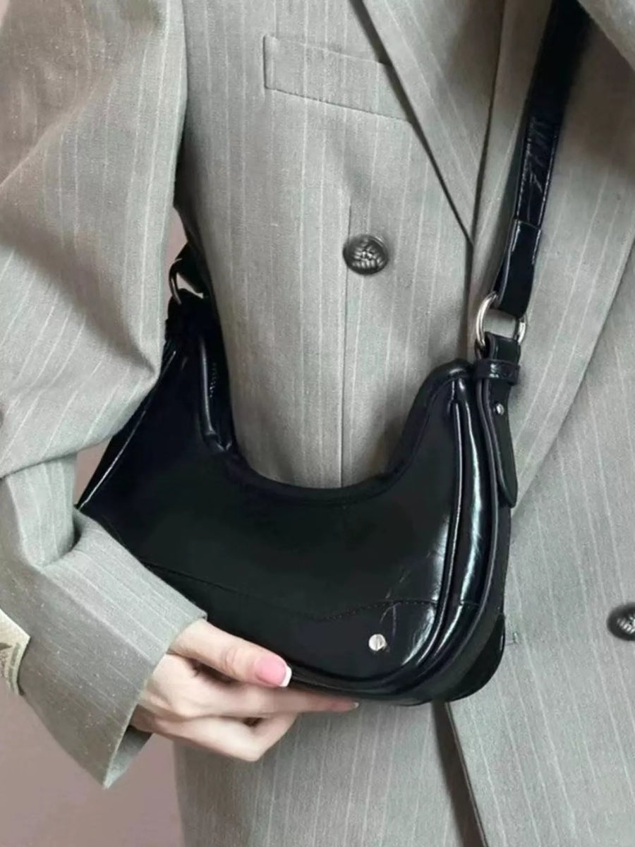 Black mini PU leather shoulder bag with shiny patent strap and silver hardware.