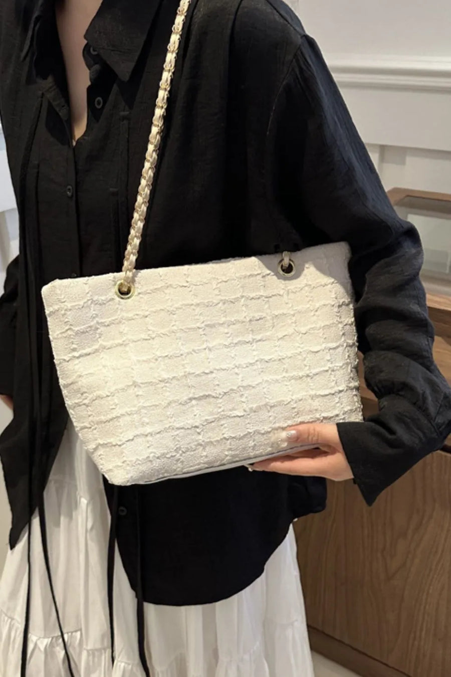 White textured bouclé shoulder bag with a braided chain strap.