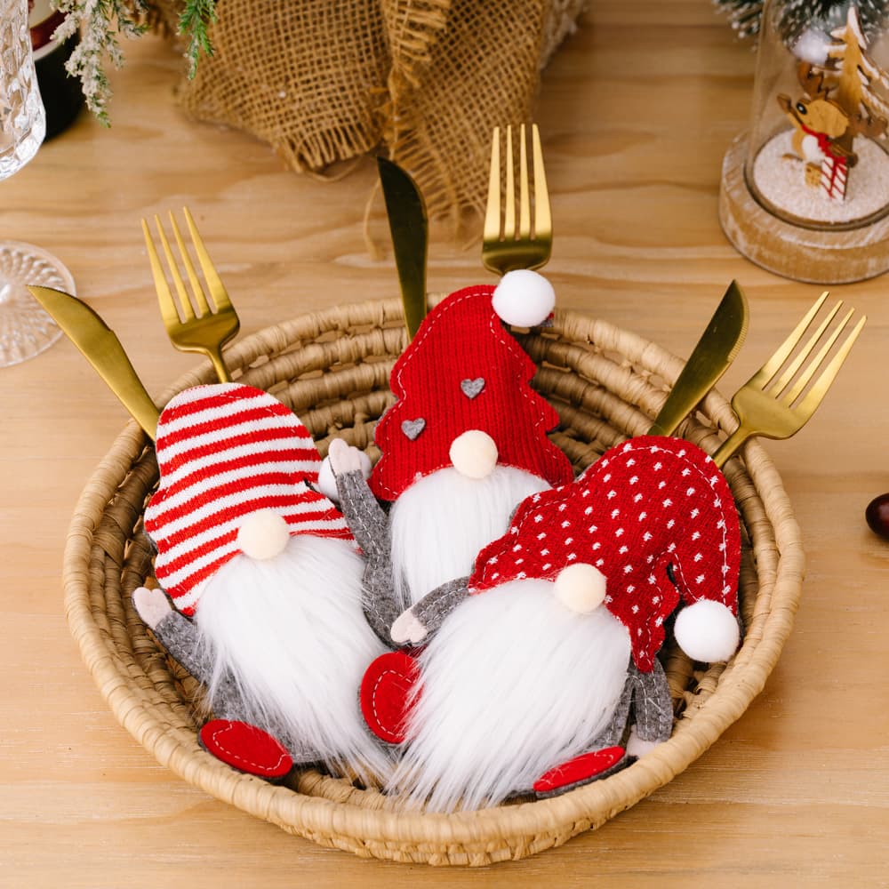 Festive gnome cutlery holders in red with white accents, perfect for holiday table settings.