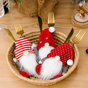 Festive gnome cutlery holders in red with white accents, perfect for holiday table settings.