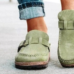 Sage suede buckle mule loafers with adjustable strap and contrast stitching.