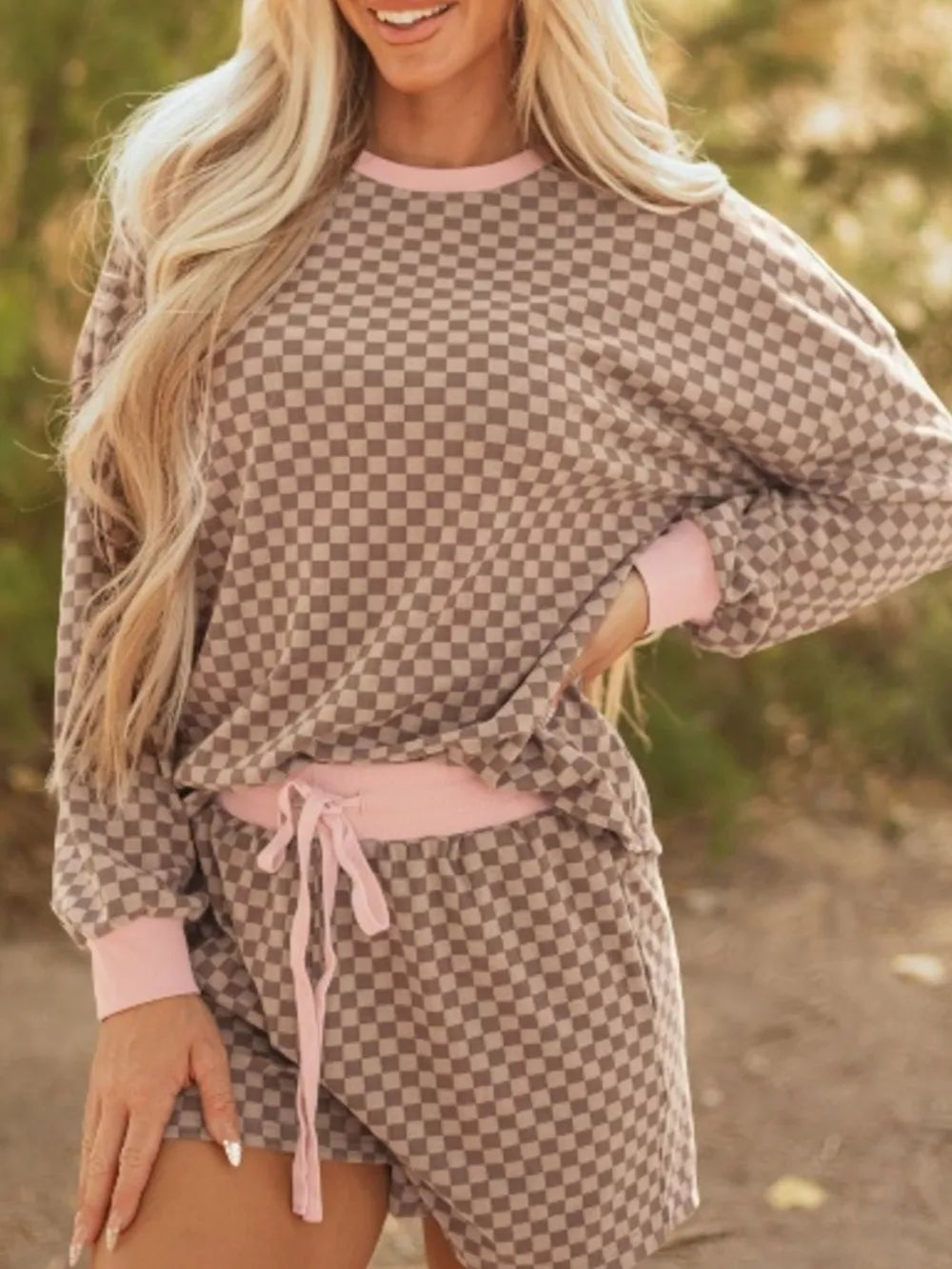 Checkerboard loungewear set with pink trim and drawstring shorts.