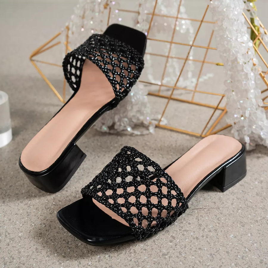 Black woven mid-heel sandals with square toe and block heel.