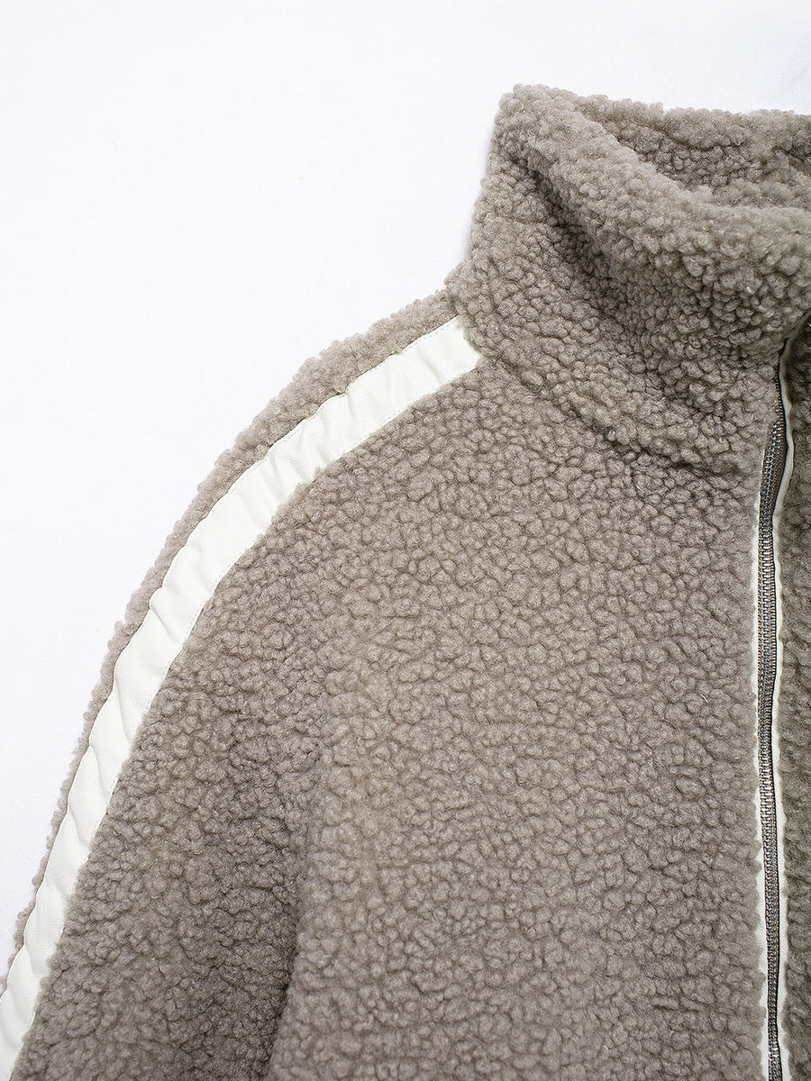 Dust Storm teddy fleece zip-up jacket with white contrast piping and high collar.