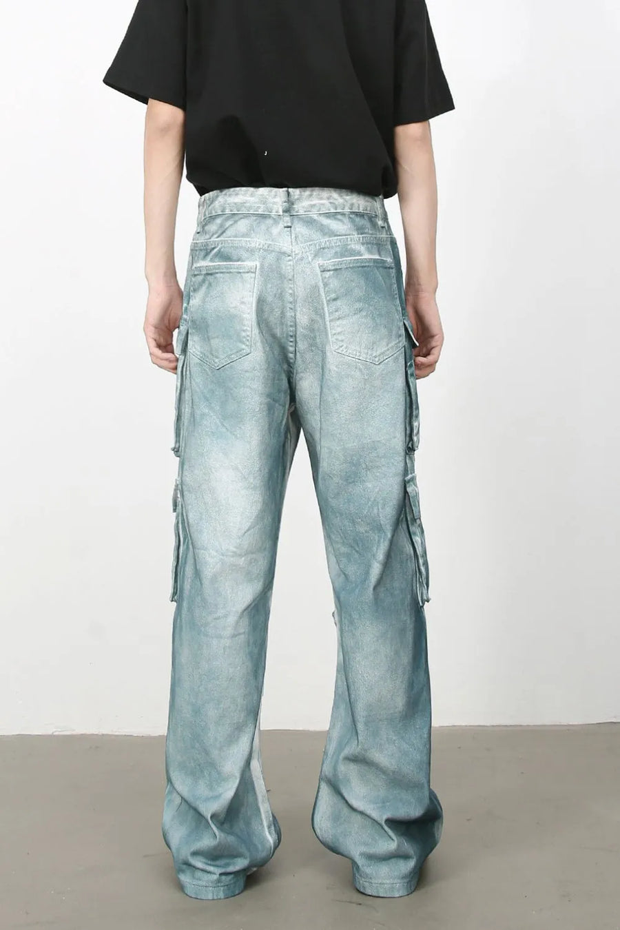Bleached denim utility trousers in medium with multiple cargo pockets and a relaxed fit.