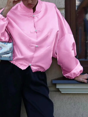 pink button-up shirt with waist-length and button-front