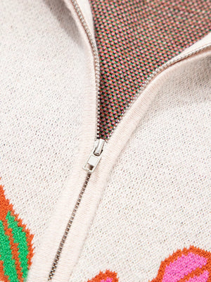 Knit quarter zip sweater with floral pattern, stand neck, and zipper detail.