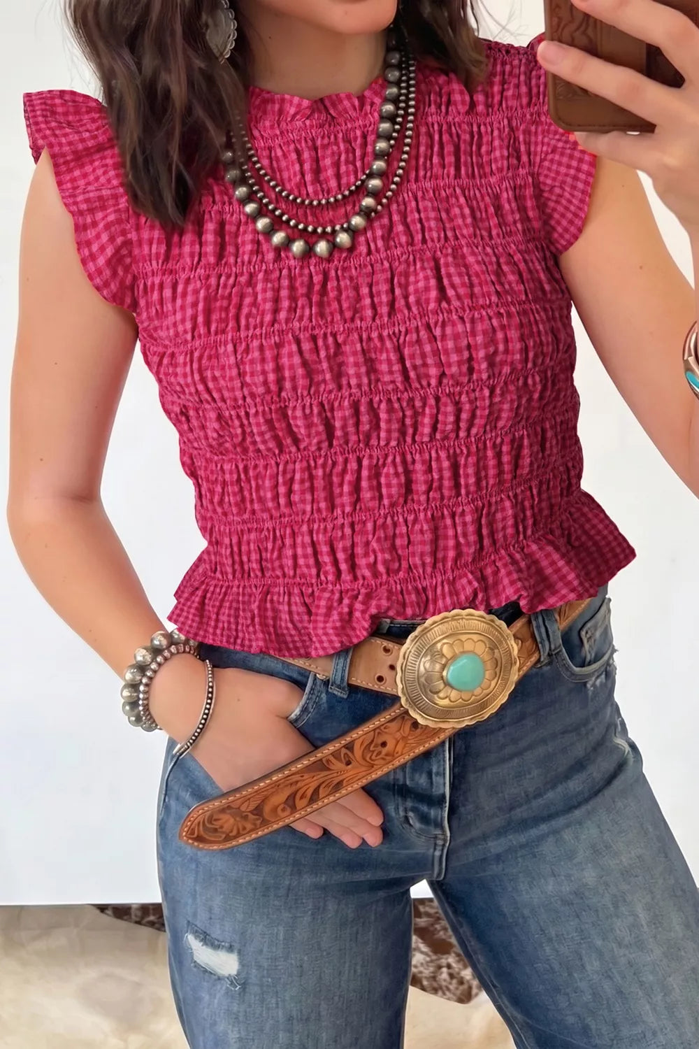 Textured smocked gingham ruffle tank top with ruffled cap sleeves and mock neckline.