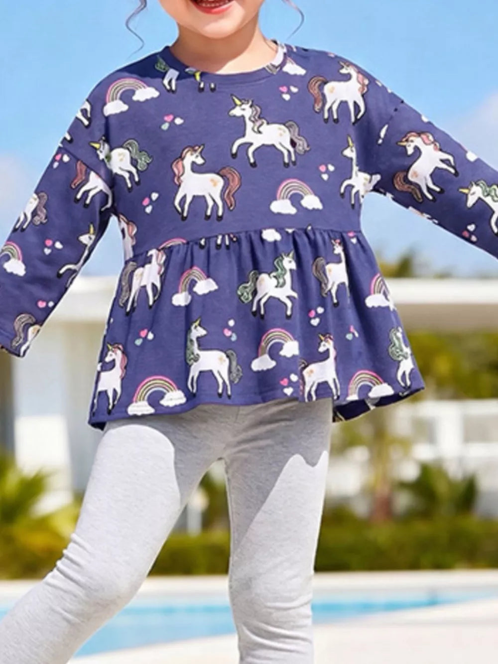 Indigo peplum top featuring tiered and unicorn print