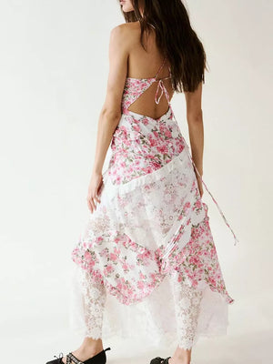 Floral lace maxi dress with ruffles and open back, featuring a pink floral print and white lace trim.