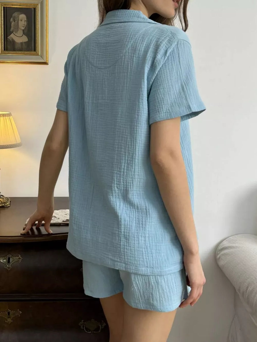 Sky blue cotton button-up shirt and shorts set with collared neckline and short sleeves.