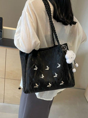 Black butterfly shopper bag with braided handles and cloud charm