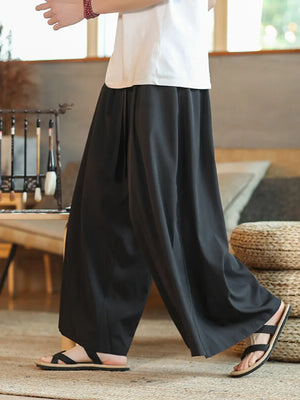 Men's black relaxed fit sweatpants with drawstring detail.