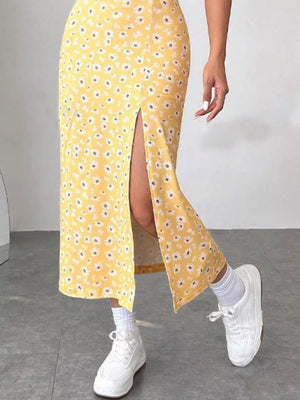 Yellow floral midi dress with a high slit, spaghetti straps, and a flowy skirt.