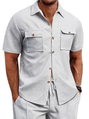 Gray textured resort shirt with short sleeves, button front, and two patch pockets.