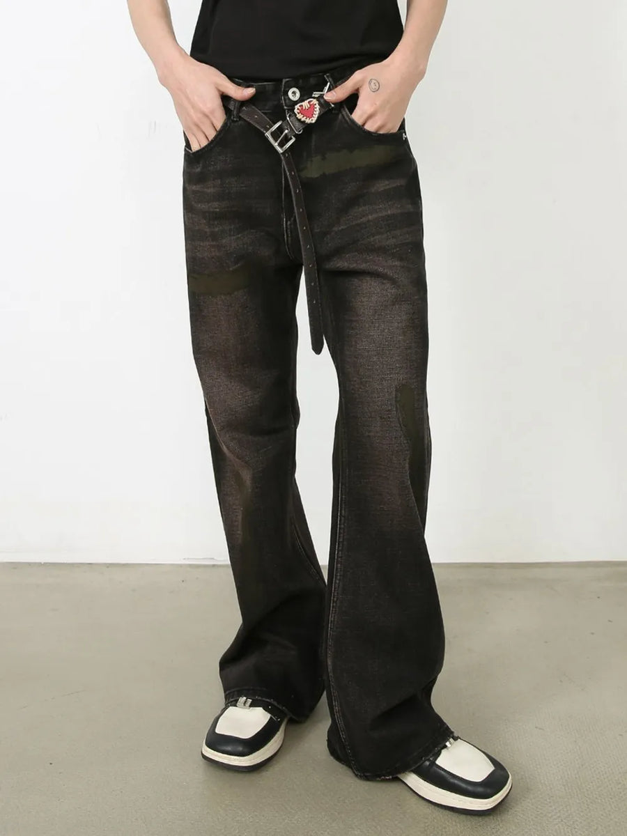 Faded flare jeans in dark distressed wash denim with a buttoned closure and belt.