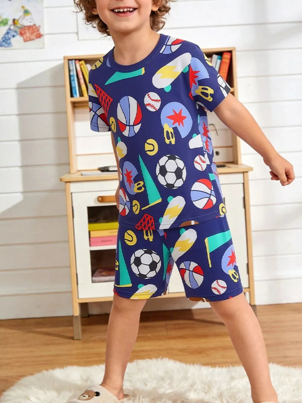 Kids' blue short sleeve tee and shorts set with all-over sports print