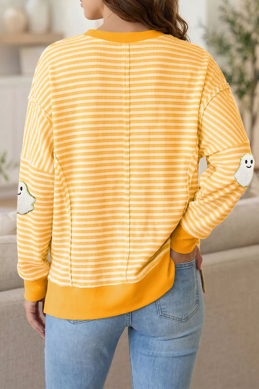 white pullover sweater featuring applique and striped