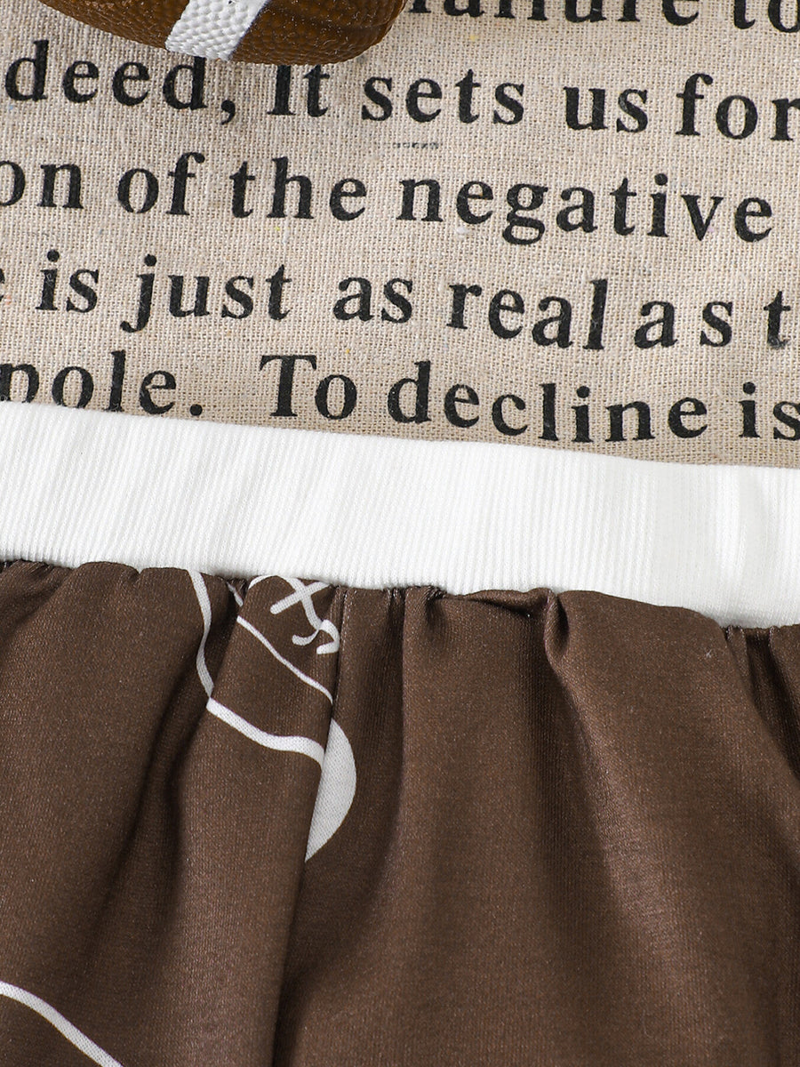 Brown baby pants with football print and text detail on top.