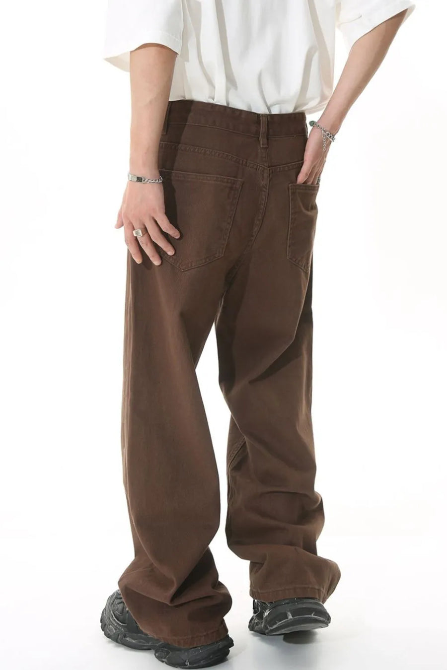 Brown wide-leg denim jeans with a relaxed fit, shown from the back.