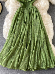 Green lace maxi dress with ruffled neckline and smocked waist detail.