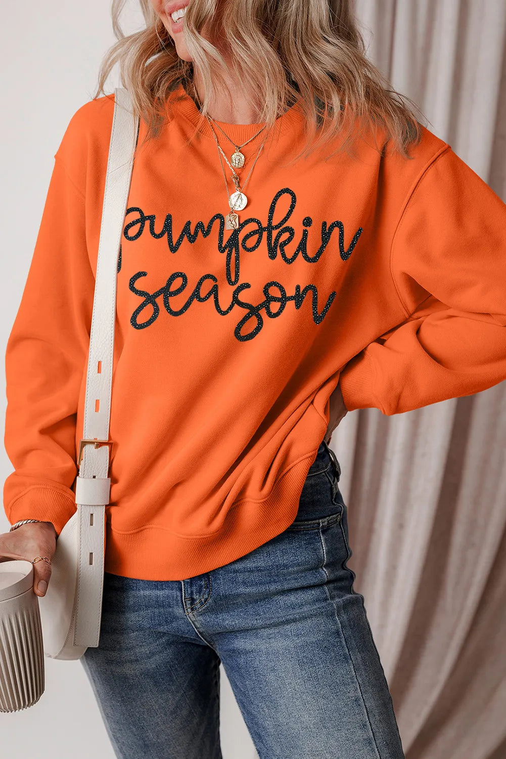 Orange graphic sweatshirt with "Pumpkin Season" text, crewneck, long sleeves, casual autumn style.