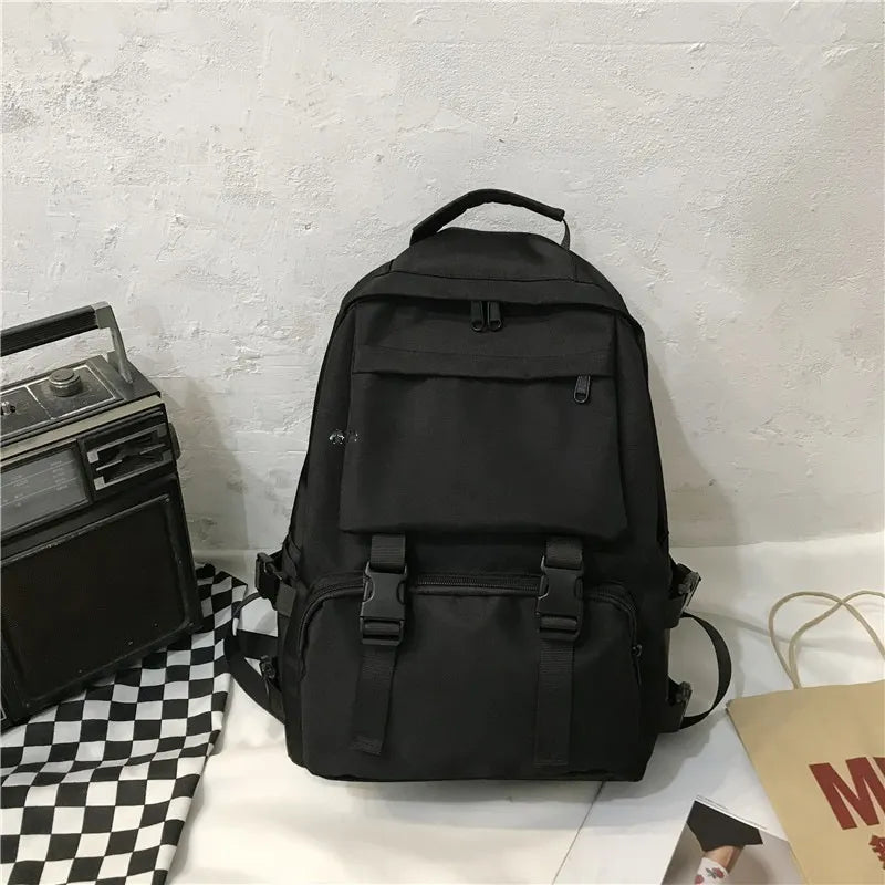 Black utility backpack with buckle details and multiple pockets
