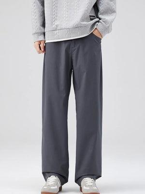 Oversized dark gray casual pants with a loose fit and cotton blend material.