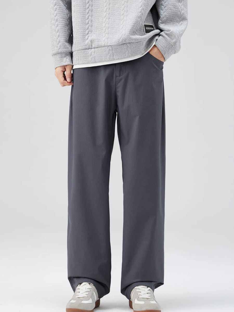 Oversized dark gray casual pants with a loose fit and cotton blend material.