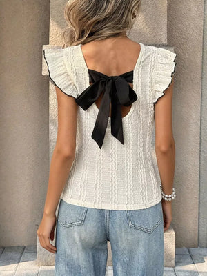 White crinkled t-shirt with ruffled sleeves and black bow back detail.