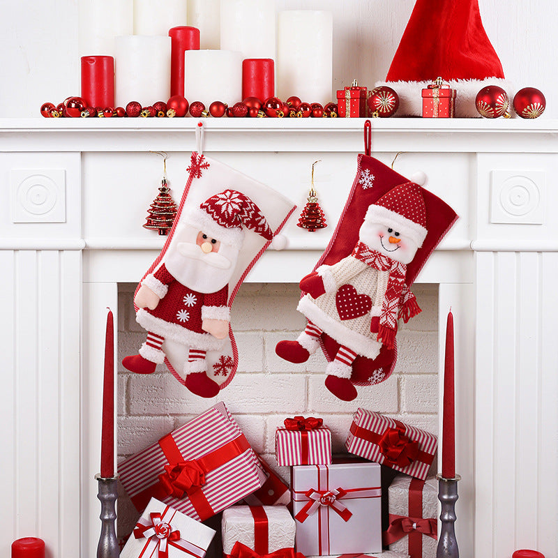 Festive plush Santa and Snowman Christmas stockings with red and white knit details.