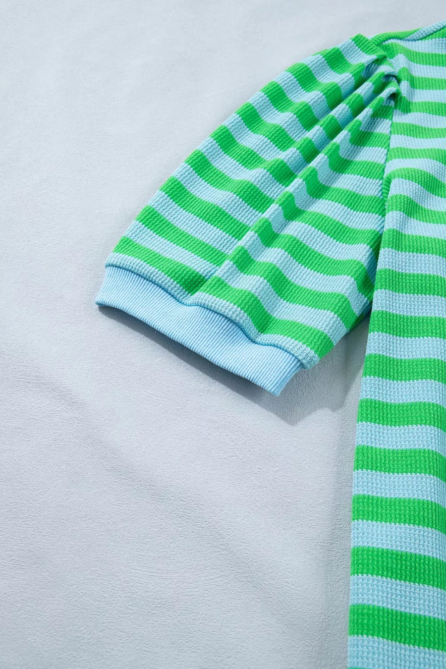 Striped waffle knit top with puff sleeves and light blue cuffs