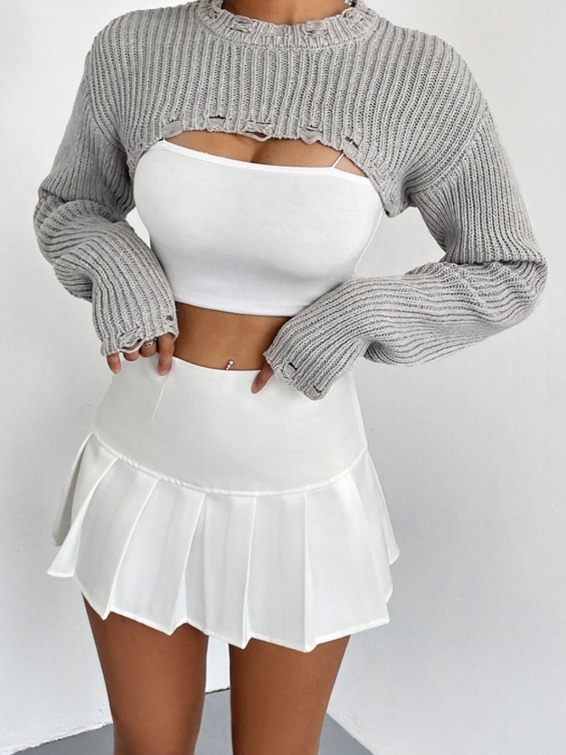 Heather gray distressed knit bolero crop top with ripped details and long sleeves.