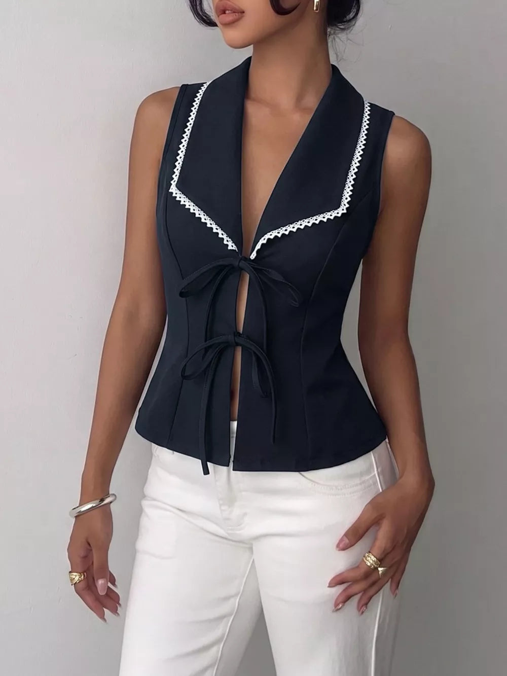 Black lace-trimmed tie-front vest with a V-neck and collar.