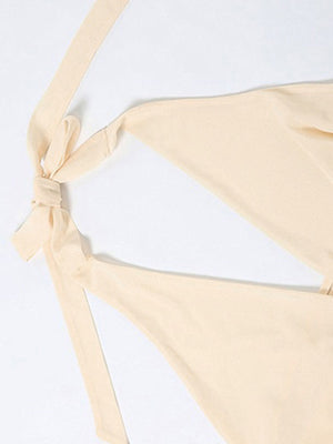 Backless mini dress with tie neck detail in beige.