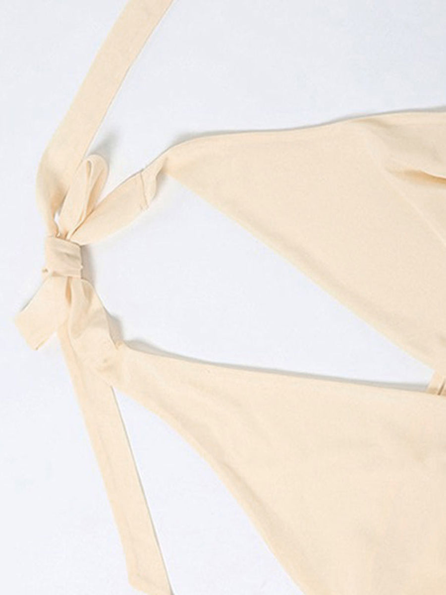 Backless mini dress with tie neck detail in beige.