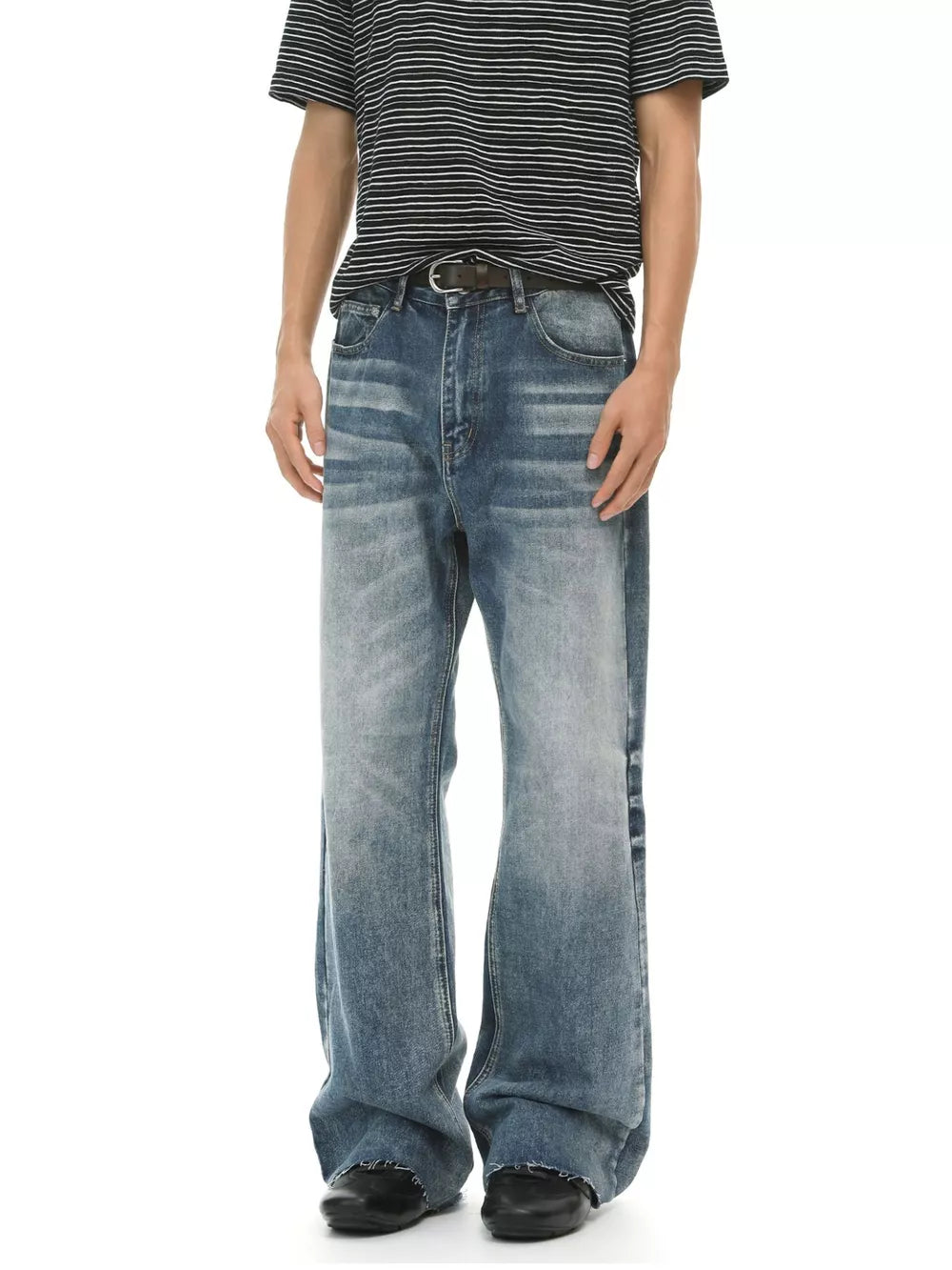 Men's blue wash cotton flare jeans with a distressed hem and faded details.