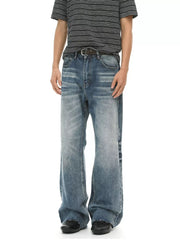 Men's blue wash cotton flare jeans with a distressed hem and faded details.